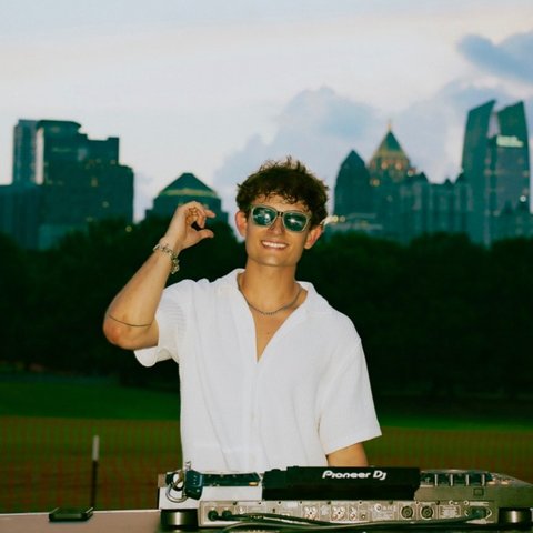 Ricky Lime DJing with the Atlanta skyline behind him
