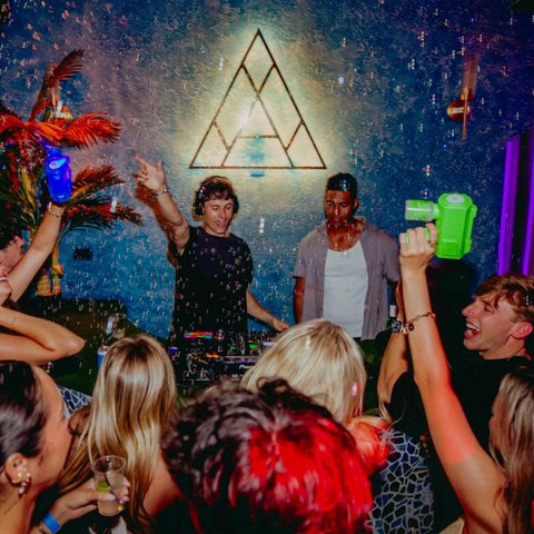 Ricky Lime DJing to a packed crowd under a cloud of bubbles